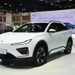 Neta X electric SUV displayed at Bangkok International Motor Show, featuring a sleek white exterior design with the Neta logo visible in the background booth
