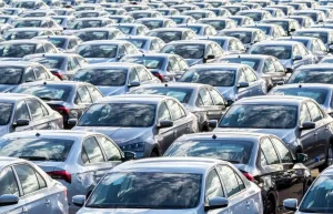 Vietnam Emerges as ASEAN's EV Powerhouse: Market Surges 24% While Regional Sales Decline 1 Rows of new dark-colored sedans arranged in a vehicle storage lot, representing Vietnam's expanding automotive market in 2025