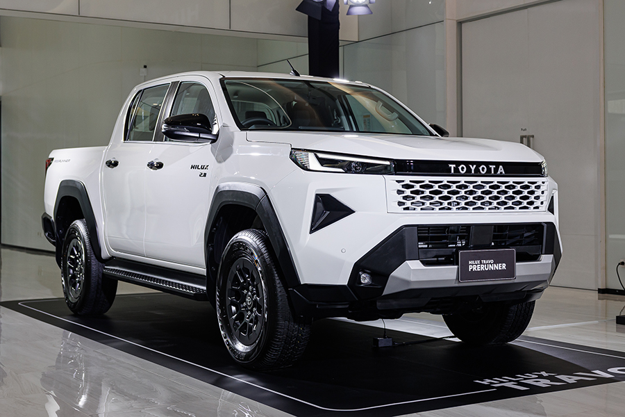 Toyota Hilux Travo Launches in Thailand: Key Specifications, Pricing, and Market Implications 4 Toyota Hilux Travo Prerunner in white, shown in a showroom with front three-quarter view highlighting its new grille and elevated ride height.