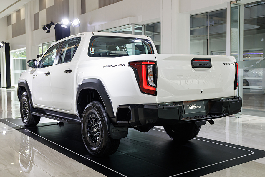 Toyota Hilux Travo Launches in Thailand: Key Specifications, Pricing, and Market Implications 5 Rear three-quarter view of the Toyota Hilux Travo Prerunner in white, showing redesigned tailgate, vertical LED taillights, and elevated ride height.